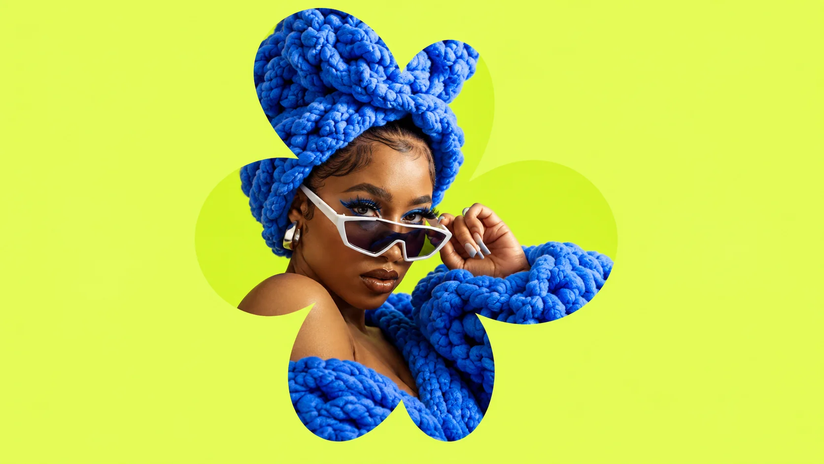 A model in sculptural cobalt knitwear is cropped inside a four-petal flower on acid lime.