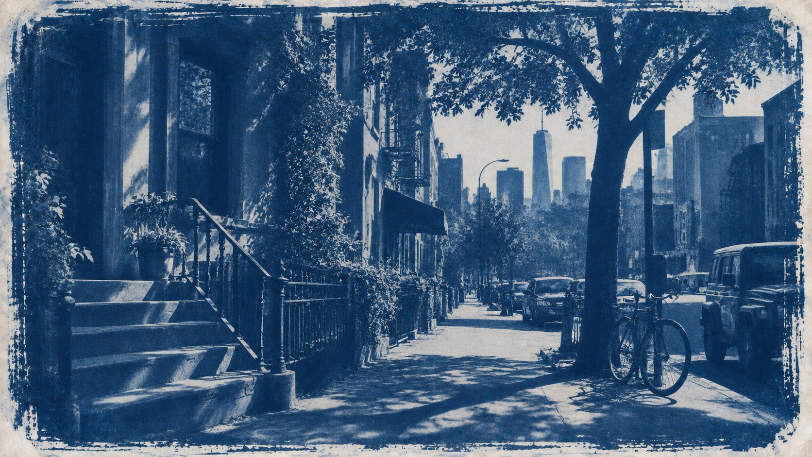 A brownstone street with stoops, trees and a distant skyline, printed as a cyanotype in deep blue and paper white.
