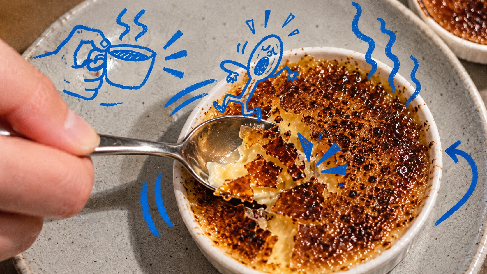 Cobalt doodles react to a spoon cracking the caramelized surface of a dessert.